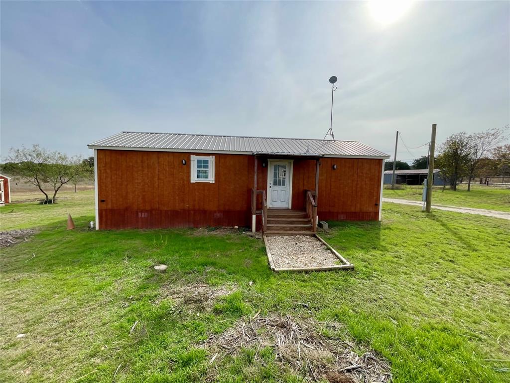 214 Cedar Creek Park Road Whitney, TX 76692 - Photo 25 of 32 a backyard of a house with table and chairs