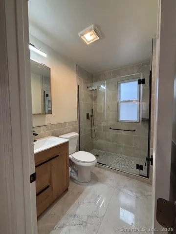 a bathroom with a double vanity sink toilet and shower