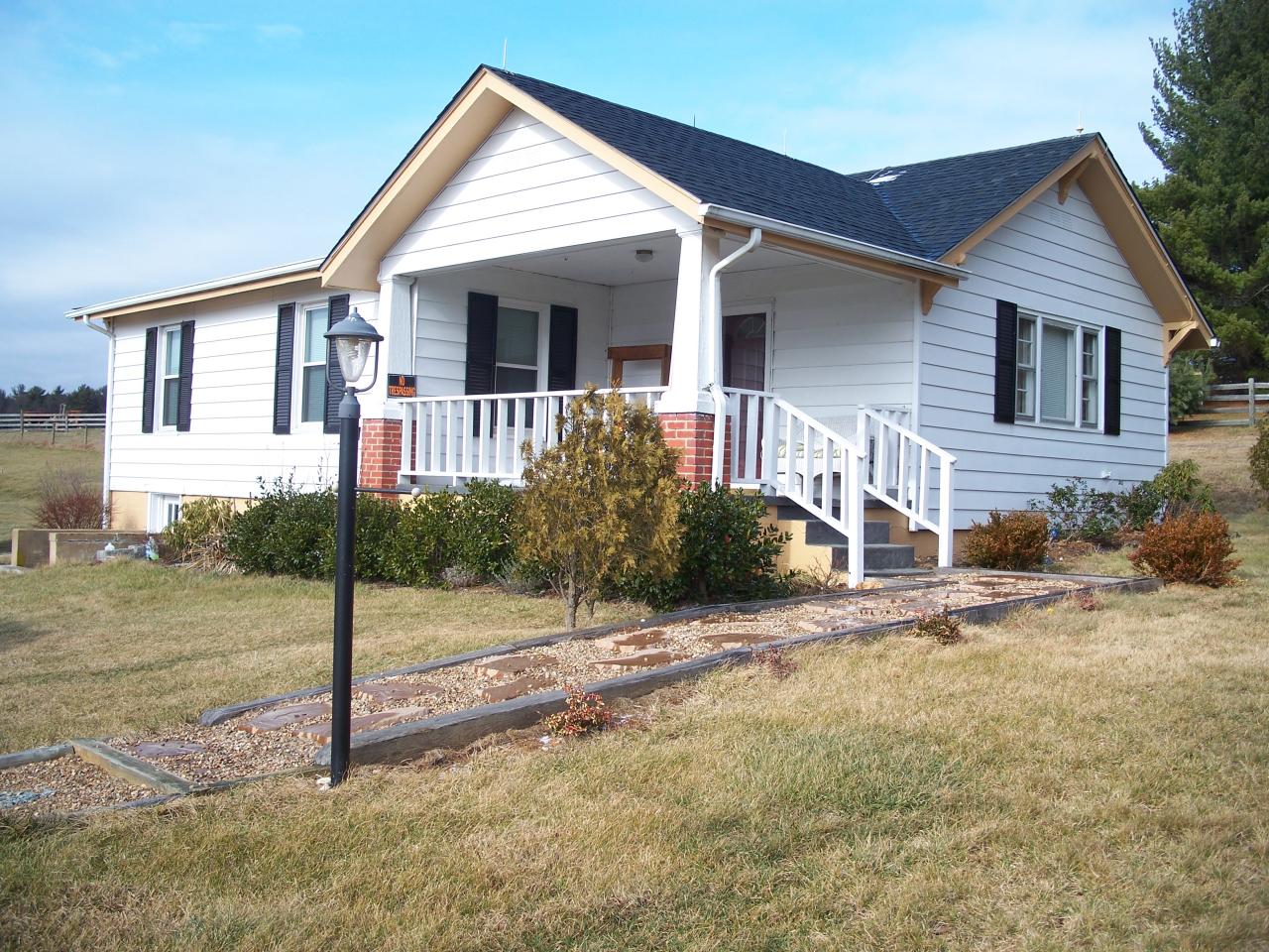 a view of a house with small yard and plants