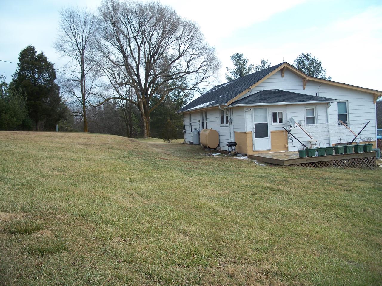 1208 Huffville Road Northeast Pilot, VA 24138 - Photo 4 of 5 a front view of a house with a yard and fence