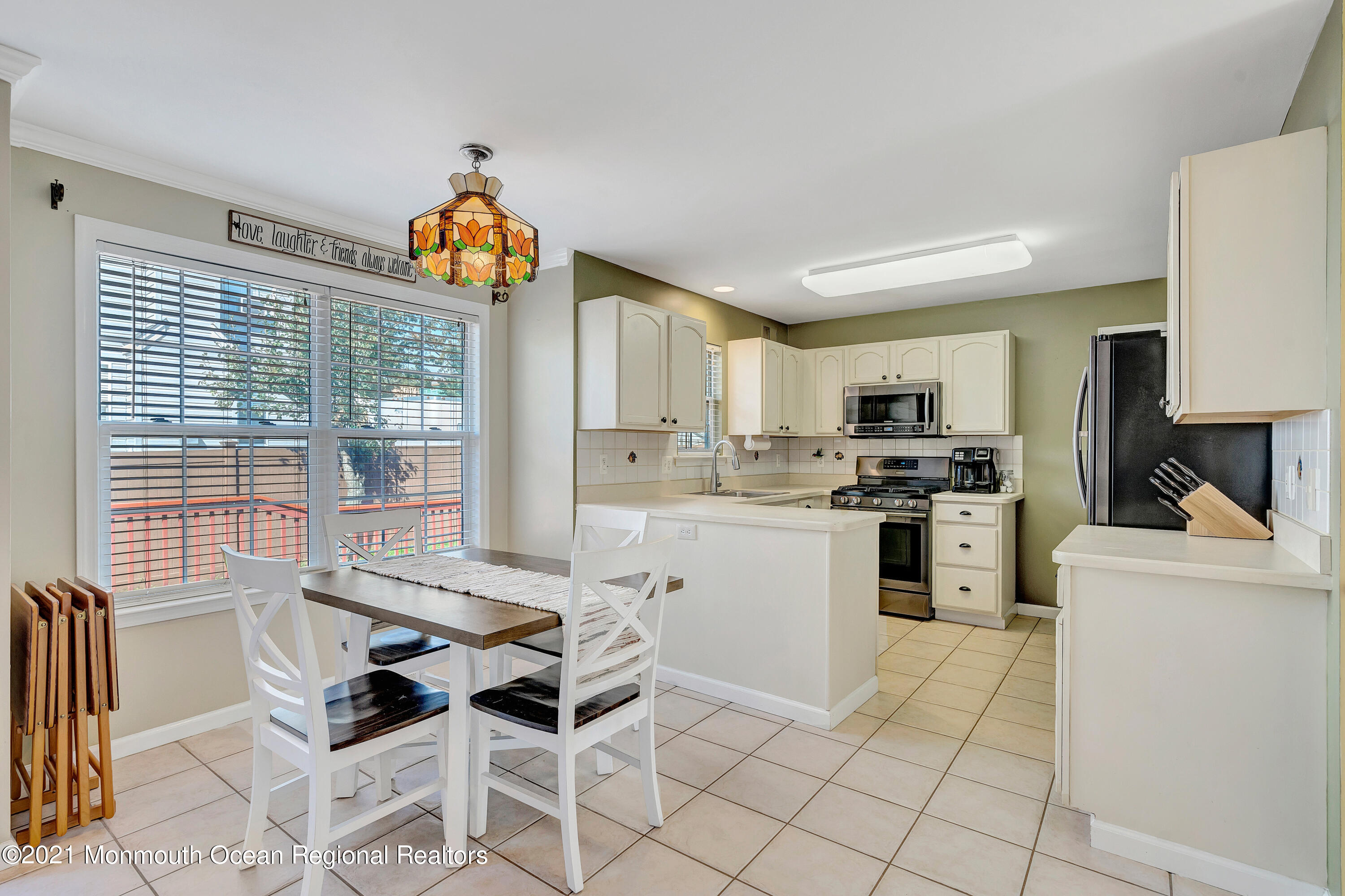101 Longboat Road Manahawkin, NJ 08050 - Photo 16 of 47 a kitchen with white cabinets and appliances
