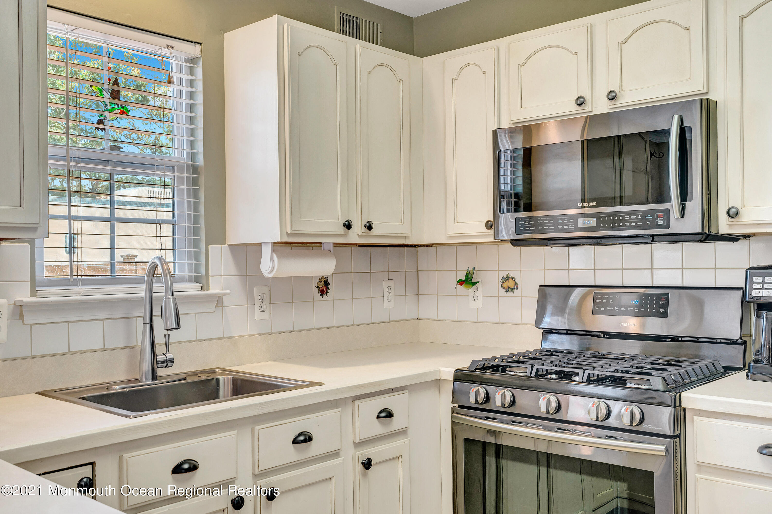 101 Longboat Road Manahawkin, NJ 08050 - Photo 20 of 47 a kitchen with granite countertop a sink a stove and cabinets