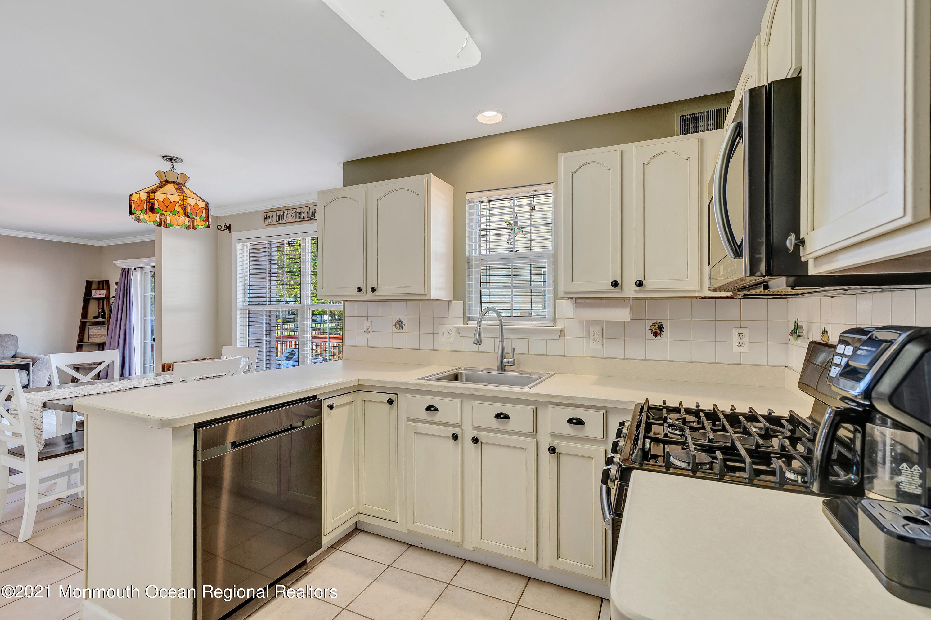101 Longboat Road Manahawkin, NJ 08050 - Photo 21 of 47 a kitchen with a sink a stove and cabinets