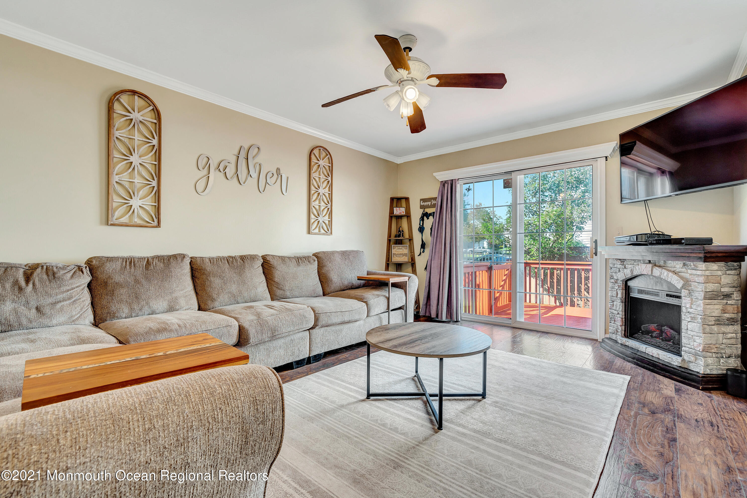101 Longboat Road Manahawkin, NJ 08050 - Photo 23 of 47 a living room with furniture and a fireplace