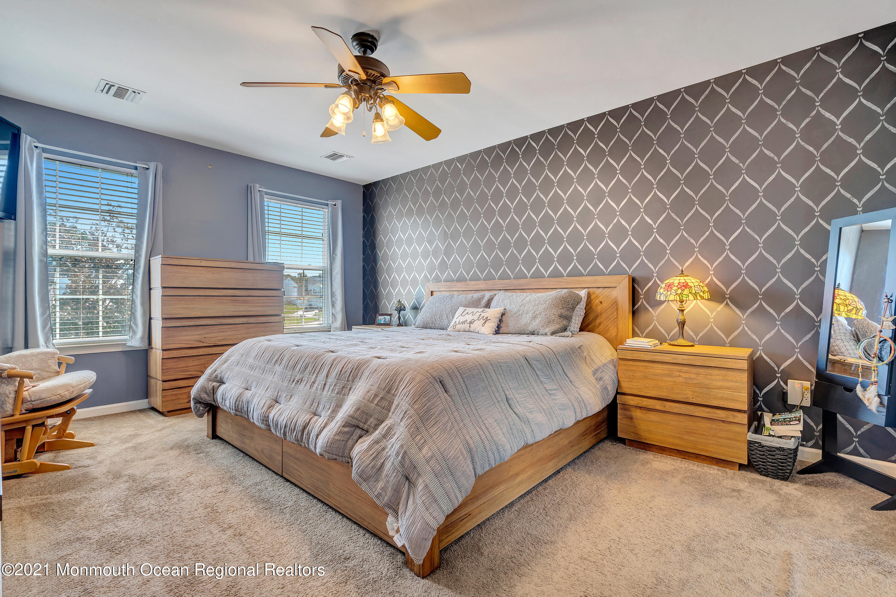 101 Longboat Road Manahawkin, NJ 08050 - Photo 27 of 47 a bedroom with a bed and a chandelier