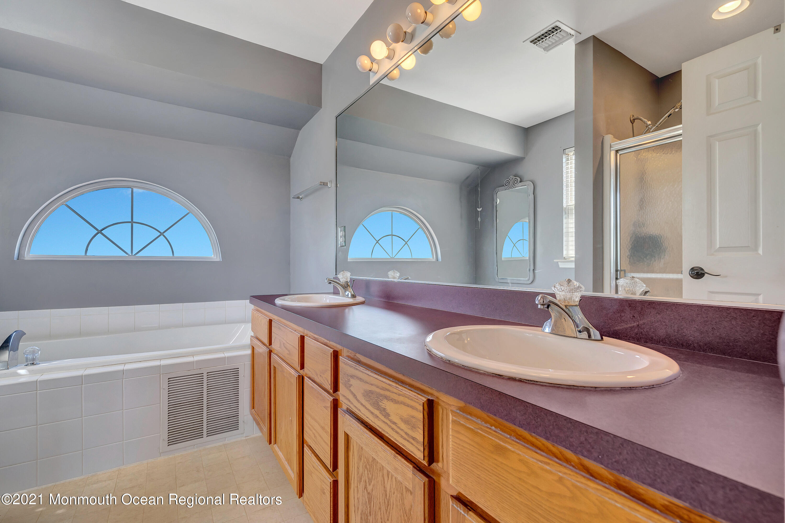 101 Longboat Road Manahawkin, NJ 08050 - Photo 28 of 47 a bathroom with a sink a vanity and a mirror