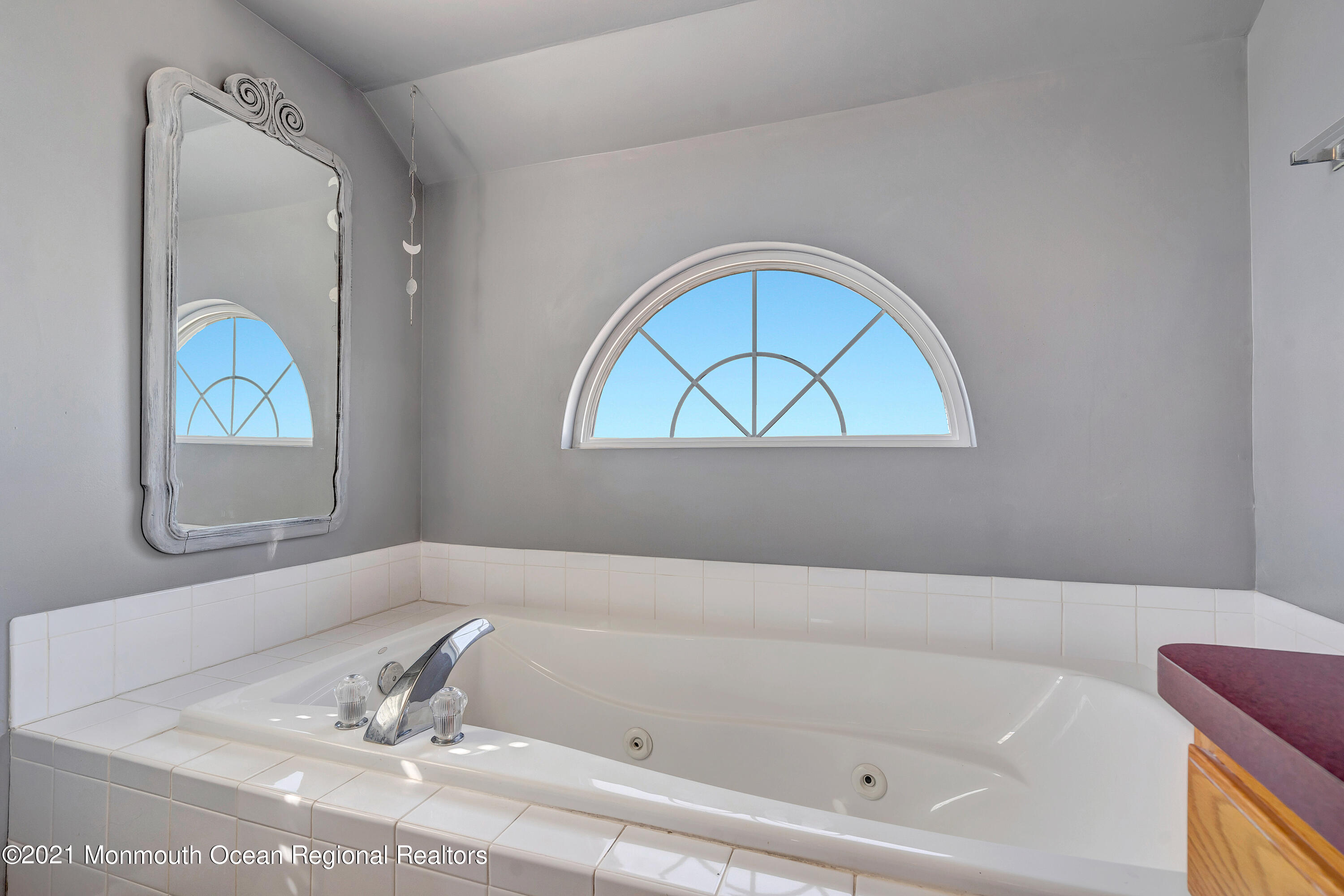 101 Longboat Road Manahawkin, NJ 08050 - Photo 29 of 47 a bathroom with a tub and a window