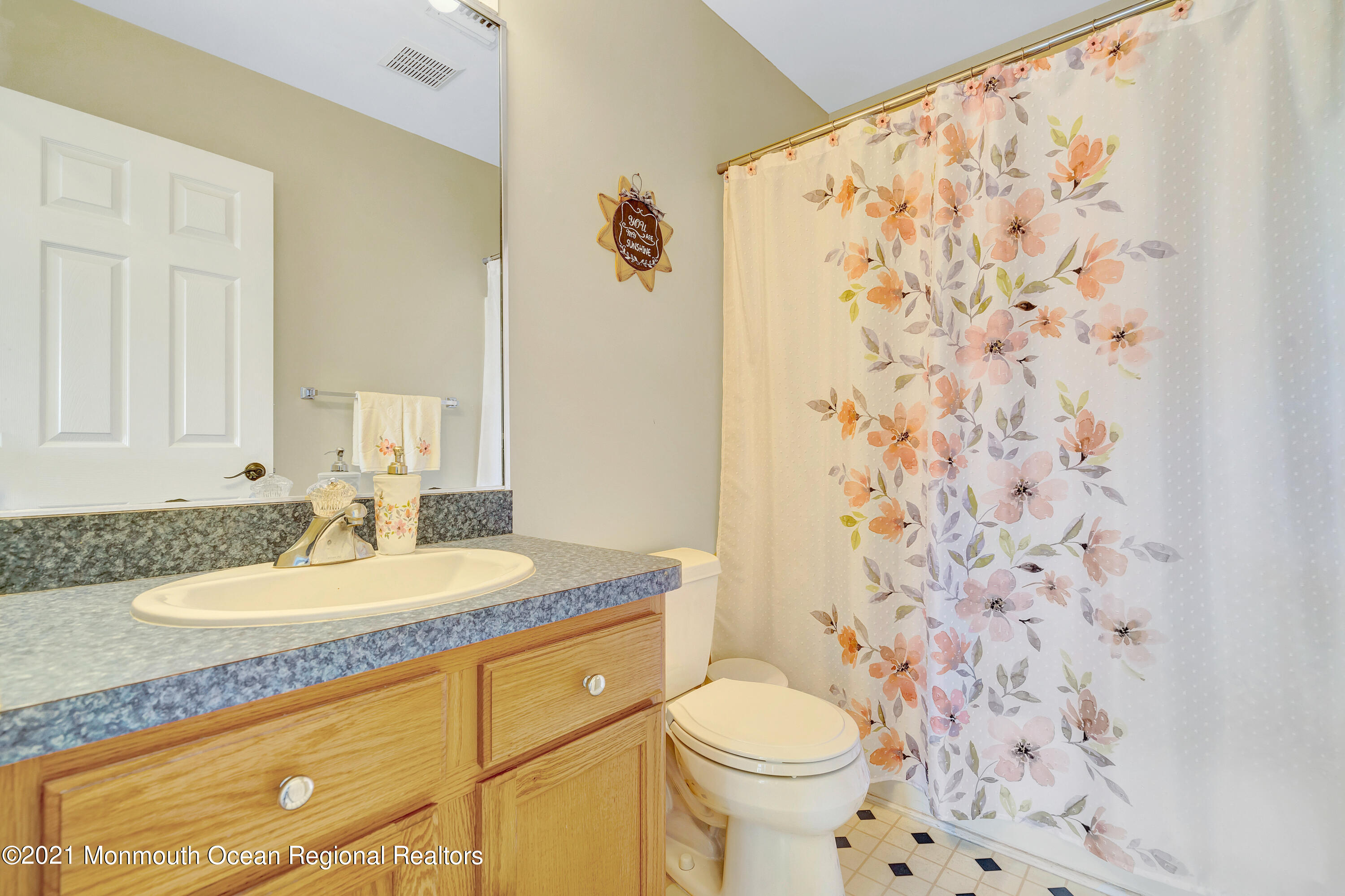 101 Longboat Road Manahawkin, NJ 08050 - Photo 32 of 47 a bathroom with a granite countertop sink a toilet and a mirror