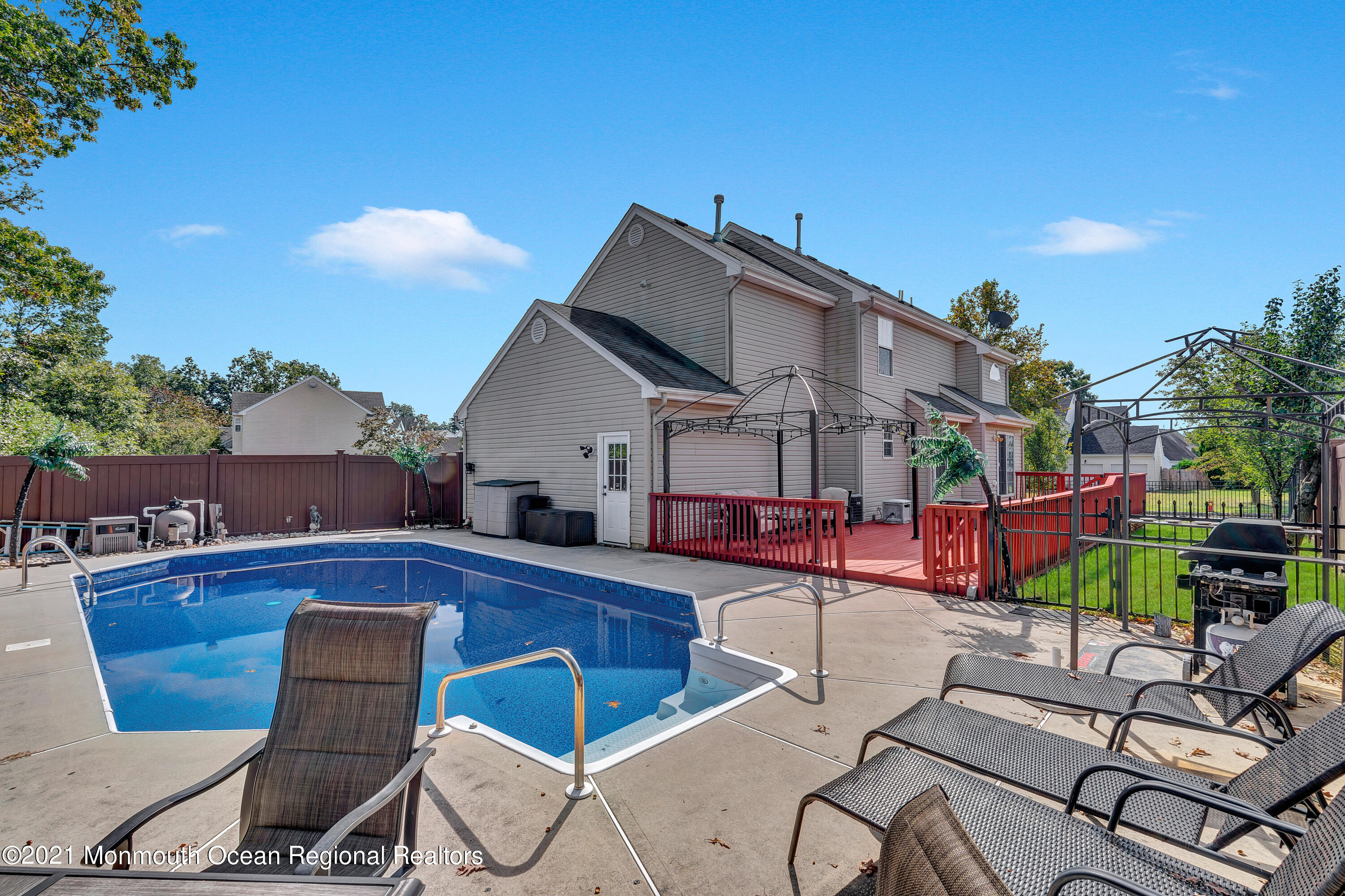 101 Longboat Road Manahawkin, NJ 08050 - Photo 36 of 47 a view of a patio with couches and table and chairs with wooden fence and plants