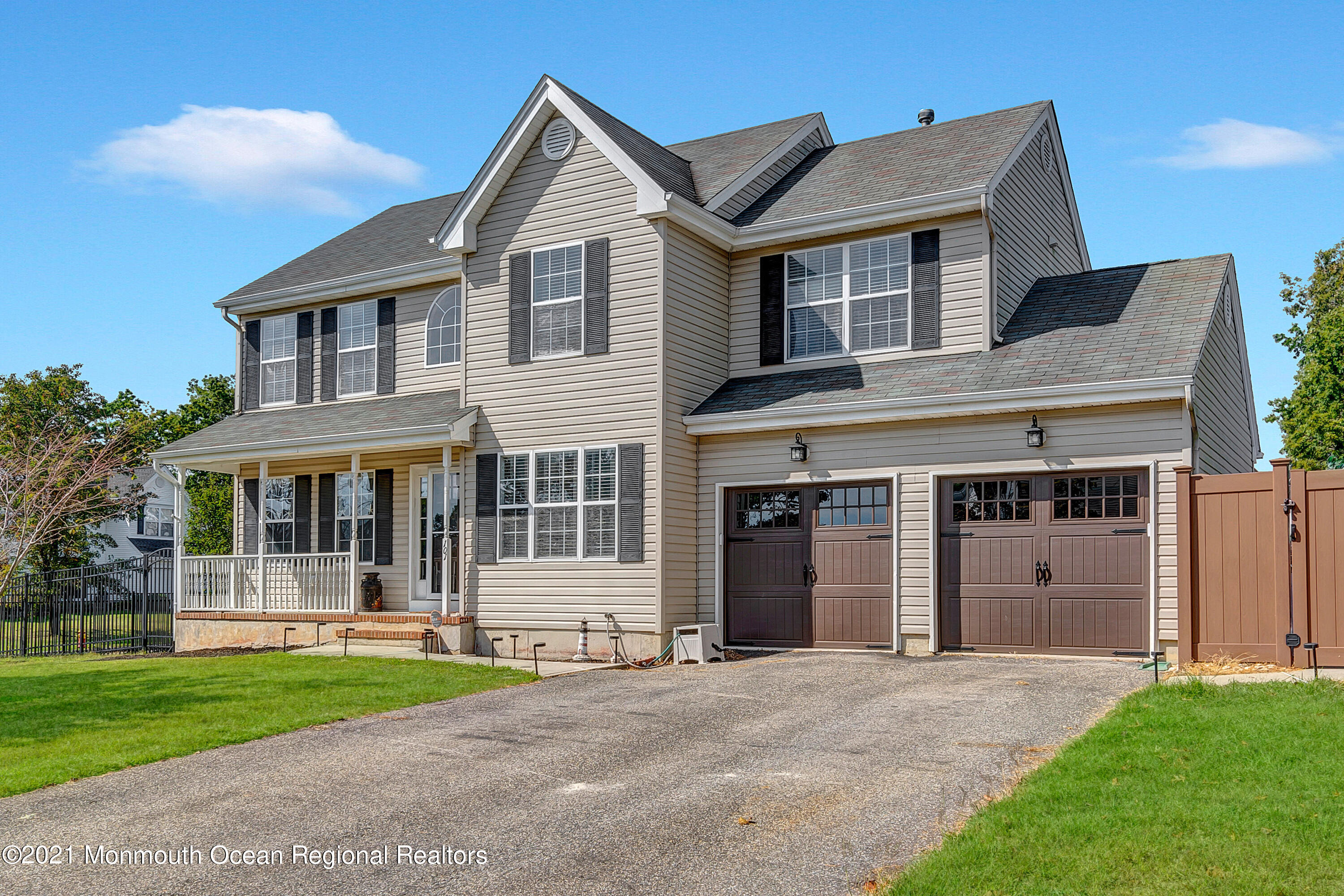 101 Longboat Road Manahawkin, NJ 08050 - Photo 42 of 47 a front view of a house with a yard and garage