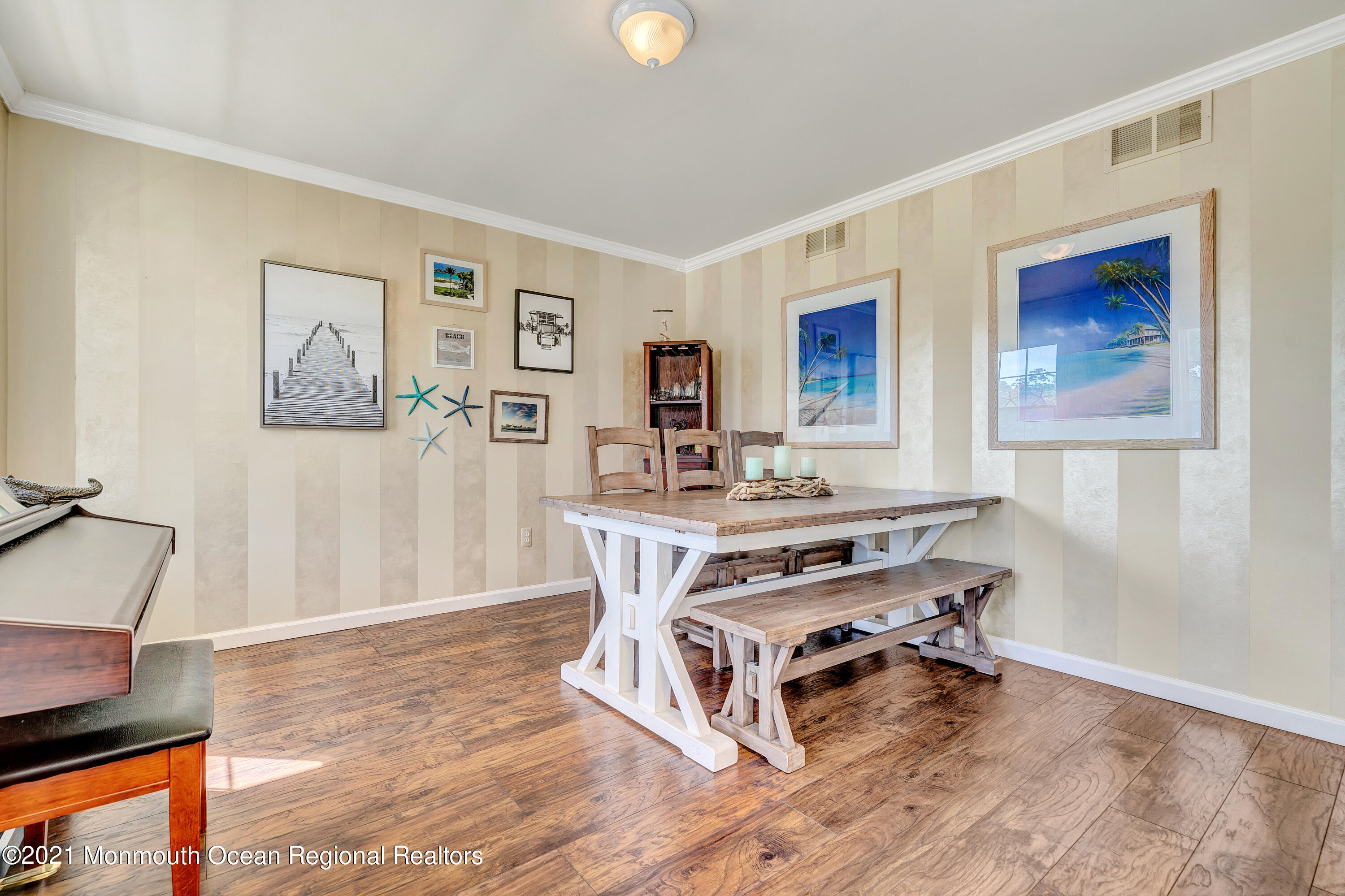 101 Longboat Road Manahawkin, NJ 08050 - Photo 7 of 47 a room with a table chairs wooden floor and a window