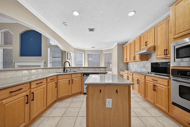 a kitchen with stainless steel appliances granite countertop a sink and cabinets