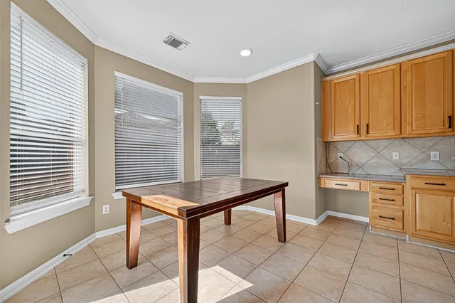 a kitchen with a sink cabinets and window