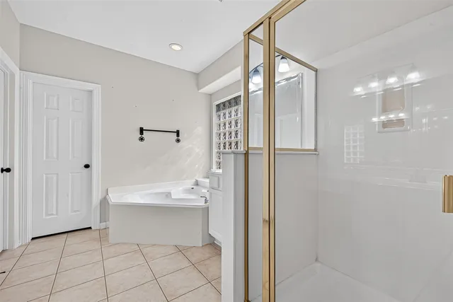 a bathroom with a bathtub and a shower