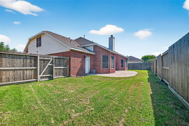 a view of a house with a yard and a garden