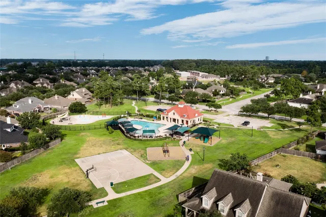 an aerial view of a house with swimming pool and ocean view