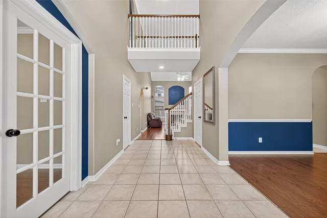 a view of a room with a flesh screen tv and windows