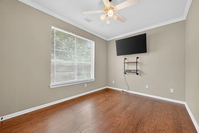 a view of livingroom with workspace wooden floor and window