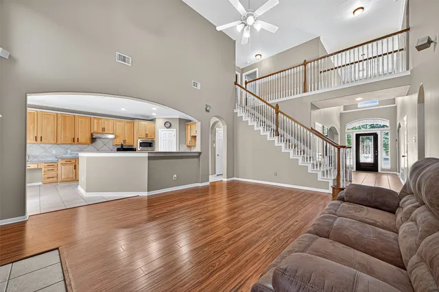 a view of a livingroom with furniture wooden floor and windows