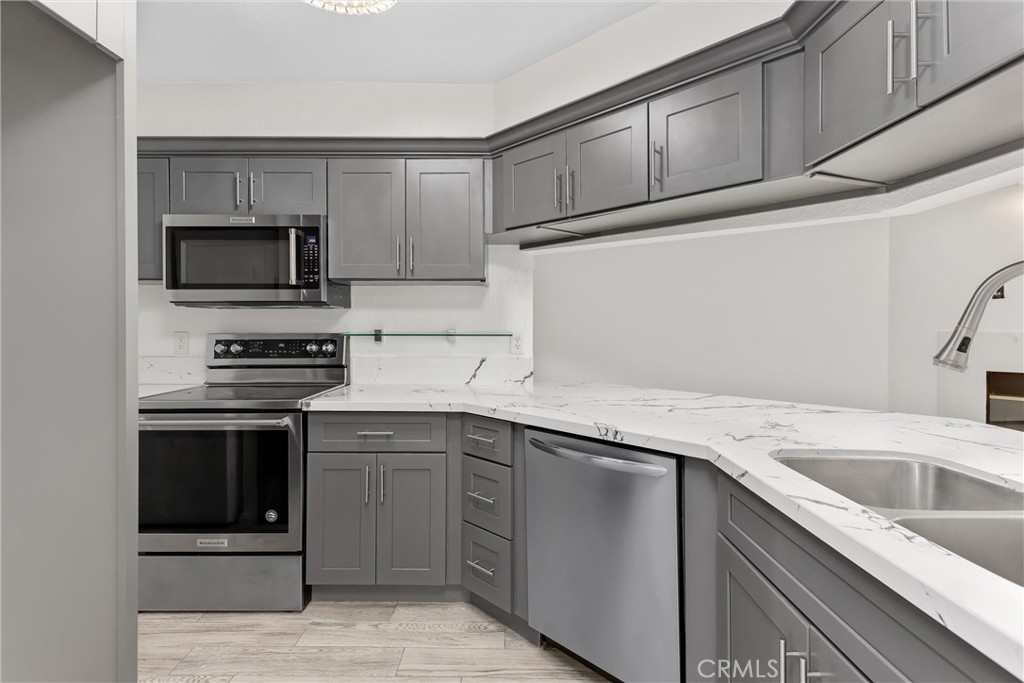 10655 Lemon Avenue, Unit 3609 Rancho Cucamonga, CA 91737 - Photo 9 of 33 Kitchen with Quartz counter tops, dishwasher, range-stove, & microwave