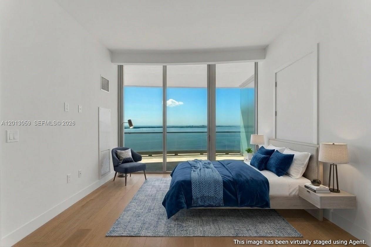 175 Southeast 25th Road, Unit 3601 Miami, FL 33129 - Photo 12 of 27 a bedroom with a bed and glass window