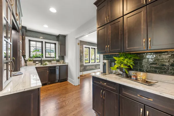 a kitchen with white cabinets and appliances