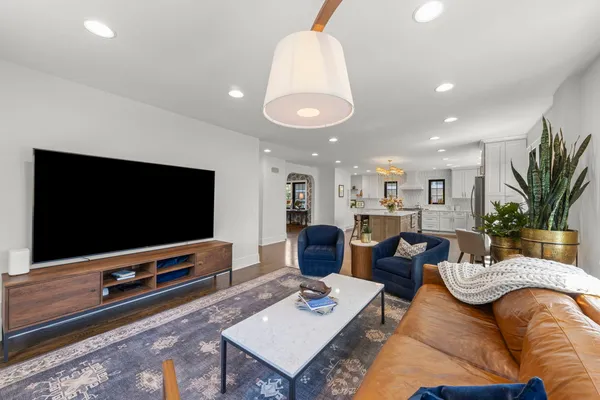a spacious bedroom with a bed and a flat screen tv
