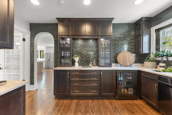 a kitchen with stainless steel appliances a refrigerator sink and white cabinets