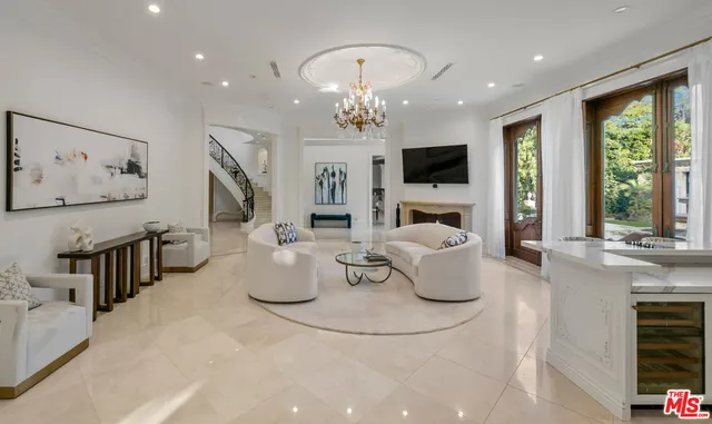a living room with fireplace furniture and a flat screen tv