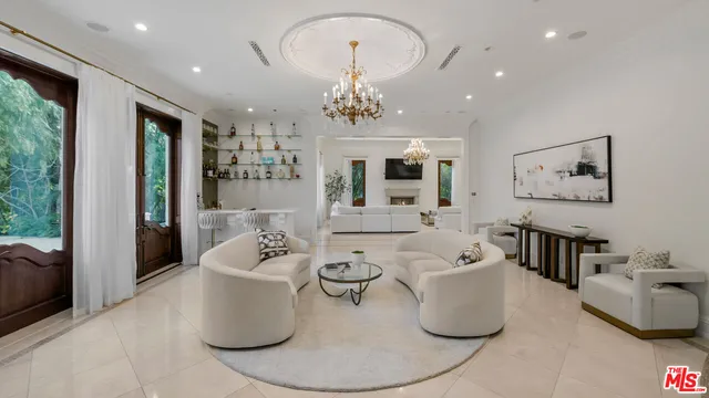 a living room with furniture and a chandelier