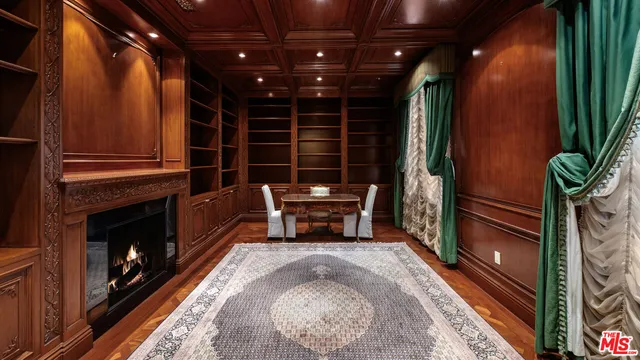 a living room with furniture a chandelier and a fireplace