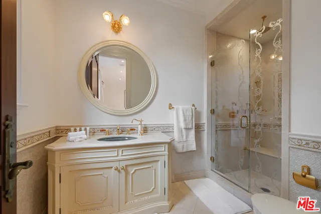 a bathroom with a sink vanity mirror and shower