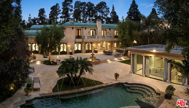 a view of a patio with table and chairs potted plants and large tree