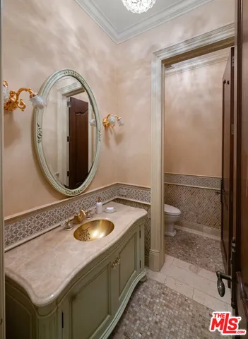 a bathroom with a granite countertop sink a toilet and shower