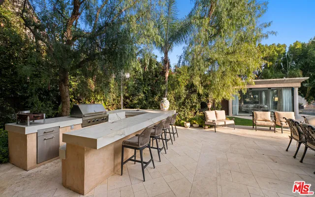 a view of a patio with table and chairs and potted plants