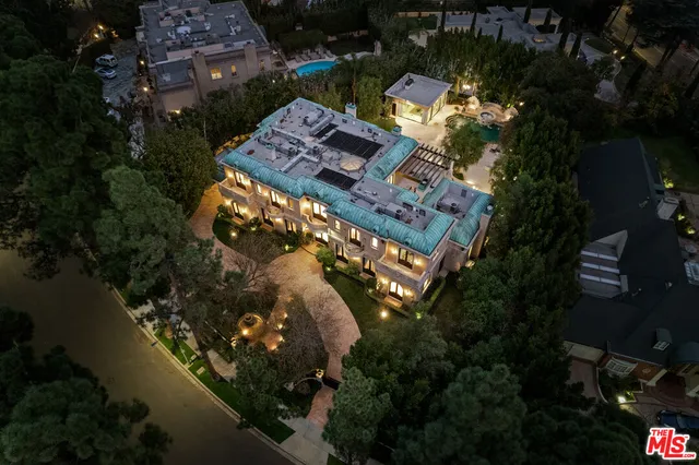 an aerial view of multiple houses with yard