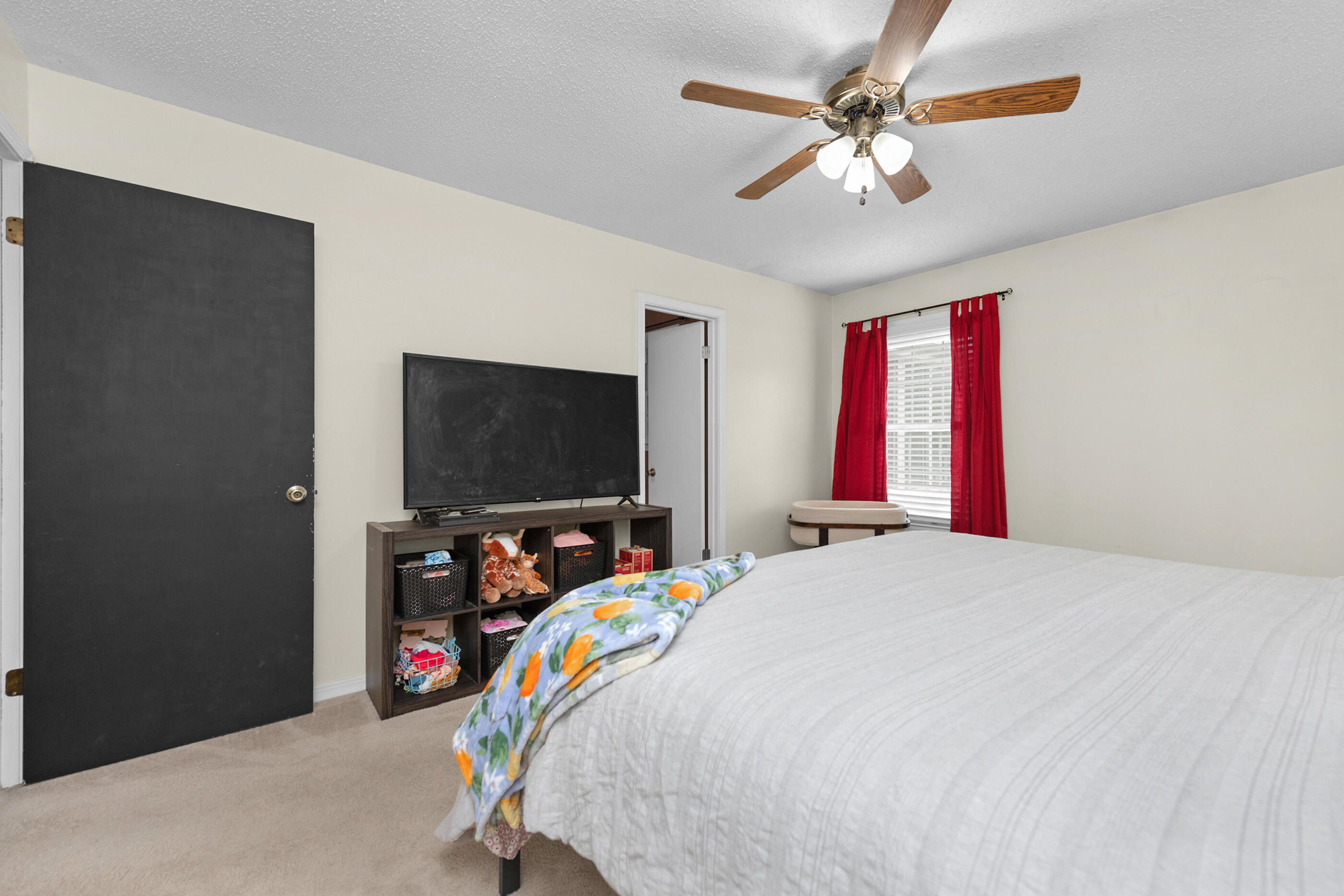 400 Brown Place Crestview, FL 32539 - Photo 11 of 24 a bedroom with a bed and a flat screen tv