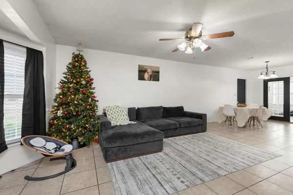 a living room with furniture and a christmas tree