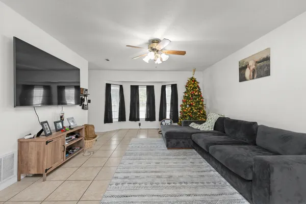 a living room with furniture and a flat screen tv