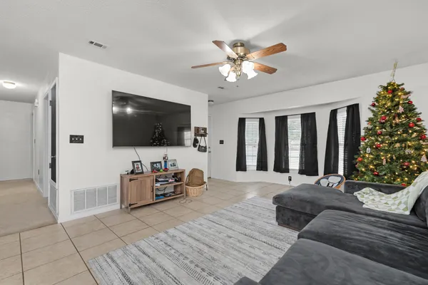 a living room with furniture and a flat screen tv