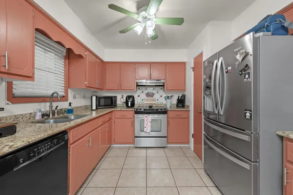 a kitchen with a refrigerator a sink and cabinets