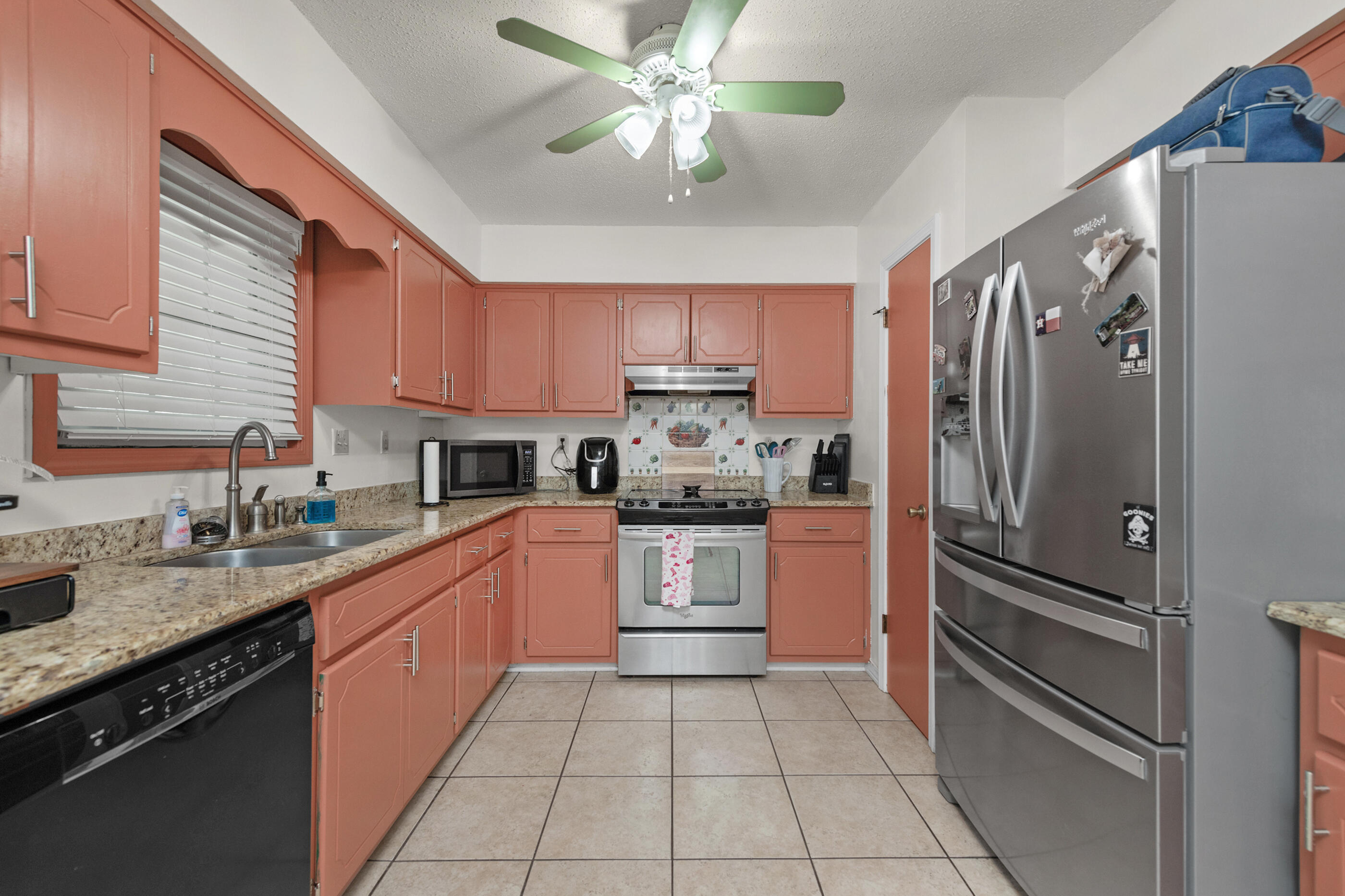 400 Brown Place Crestview, FL 32539 - Photo 7 of 24 a kitchen with a refrigerator a sink and cabinets