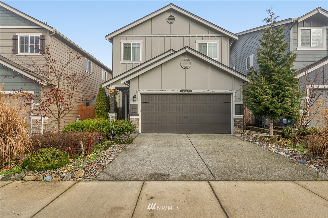 3627 202nd Pl S East Bothell, WA 98012 - Photo 1 of 38 a front view of a house with a yard and garage