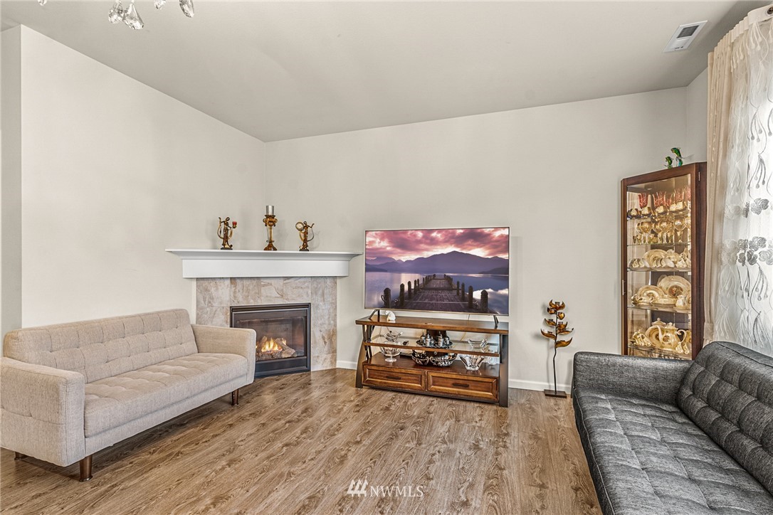 3627 202nd Pl S East Bothell, WA 98012 - Photo 11 of 38 a living room with furniture and a fireplace