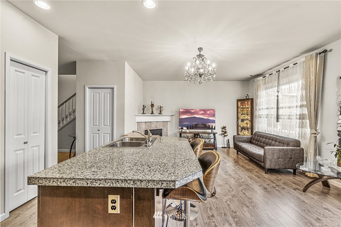 3627 202nd Pl S East Bothell, WA 98012 - Photo 15 of 38 a view of a dining room with furniture a chandelier and wooden floor