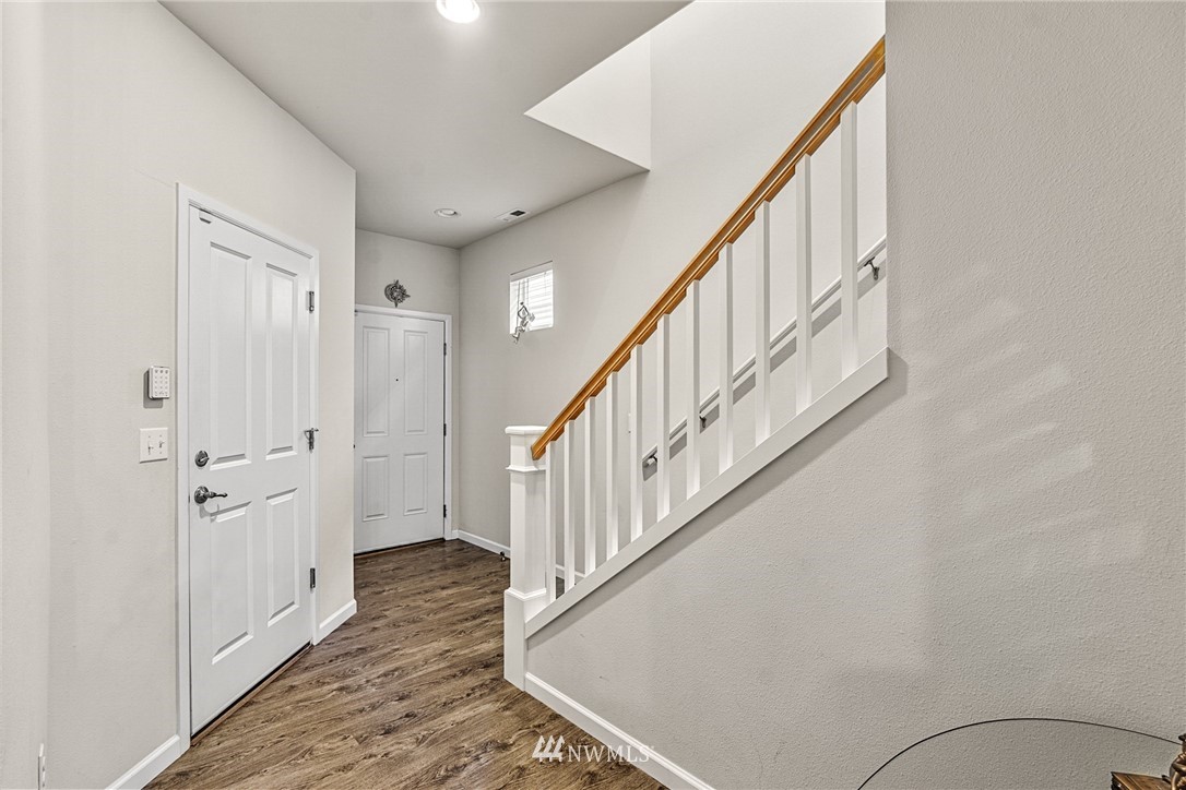 3627 202nd Pl S East Bothell, WA 98012 - Photo 16 of 38 a view of a hallway with wooden floor and staircase