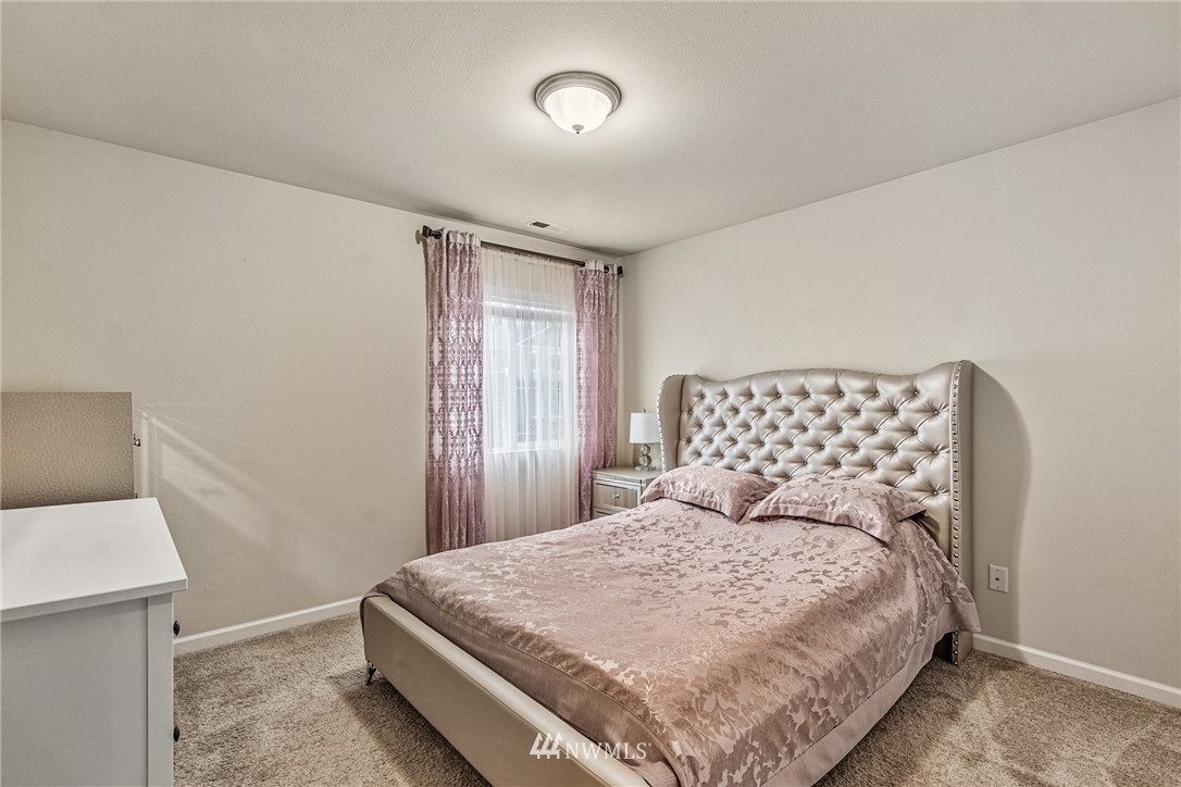 3627 202nd Pl S East Bothell, WA 98012 - Photo 21 of 38 a bedroom with a bed and a night stand