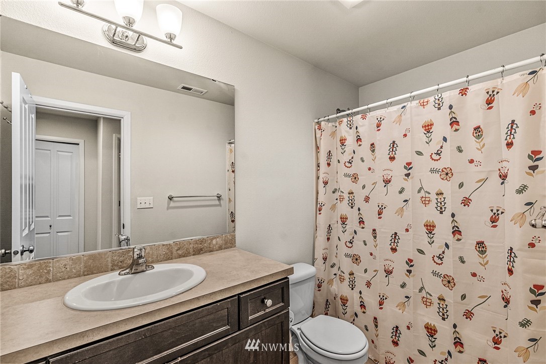 3627 202nd Pl S East Bothell, WA 98012 - Photo 23 of 38 a bathroom with a granite countertop sink a toilet and a mirror