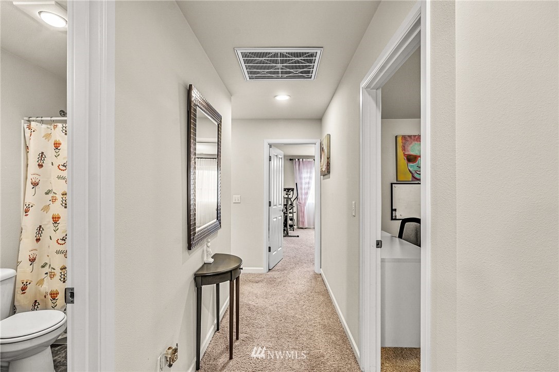 3627 202nd Pl S East Bothell, WA 98012 - Photo 25 of 38 a view of a hallway with a livingroom and a bathroom
