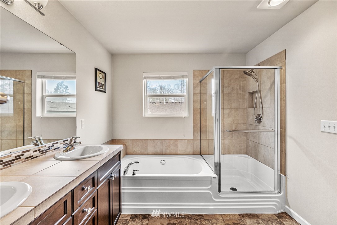 3627 202nd Pl S East Bothell, WA 98012 - Photo 31 of 38 a bathroom with a tub a sink and a shower